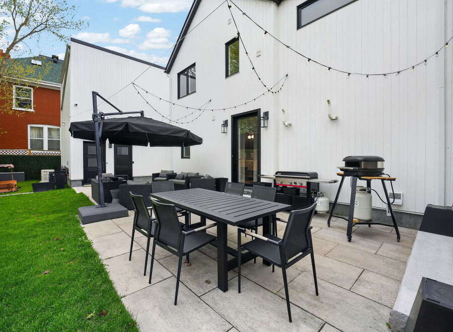 Enjoy outdoor living at its finest with this stunning property! Featuring a modern patio with a dining set, perfect for entertaining.