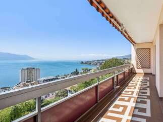 Enjoy breathtaking views from this stunning property! This home features a spacious balcony overlooking the serene lake and surrounding mountains.