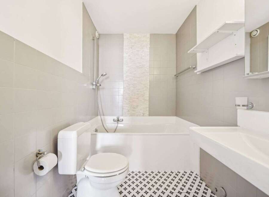 This modern bathroom features a sleek design with a combination of functionality and style.