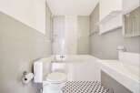 This modern bathroom features a sleek design with a combination of functionality and style.