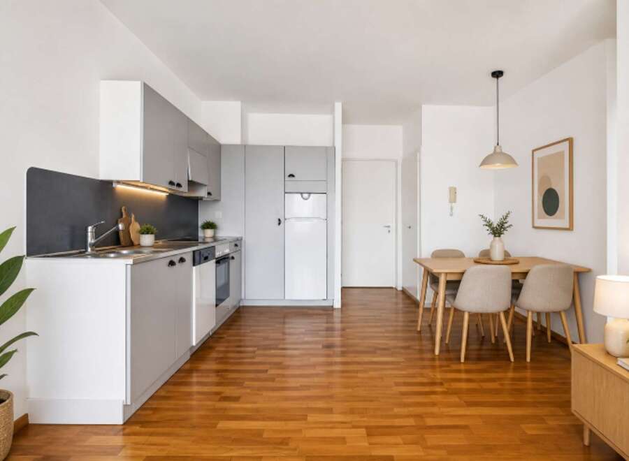 Discover modern living in this stylish apartment featuring a sleek kitchen with stainless steel appliances and ample storage.