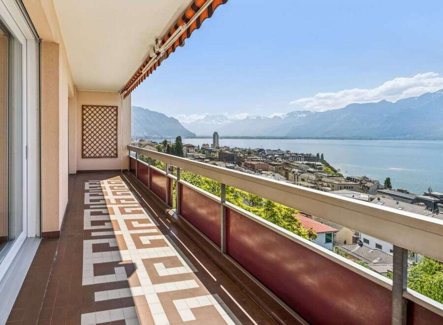Enjoy breathtaking views from this stunning balcony overlooking the city and the serene lake.