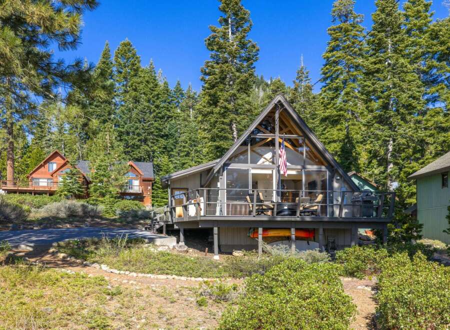 Nestled amidst towering trees, this stunning A-frame cabin offers a serene escape.