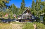 Nestled amidst towering trees, this stunning A-frame cabin offers a serene escape.