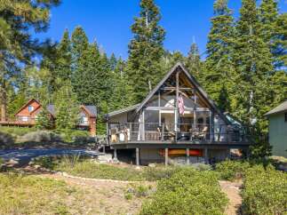 Nestled amidst towering trees, this stunning A-frame cabin offers a serene escape.