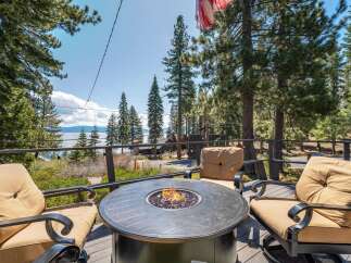 Enjoy breathtaking views from this stunning property featuring a cozy outdoor fire pit, perfect for relaxing evenings.