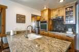 This stunning kitchen boasts a beautiful granite countertop, perfect for meal preparation and entertaining.