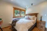 This cozy bedroom features a comfortable bed with a plush comforter and decorative pillows.