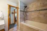 Step into this beautifully designed bathroom, featuring a luxurious bathtub and stylish tile work.