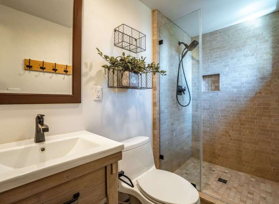 Step into a beautifully designed bathroom featuring a modern glass shower and stylish fixtures.