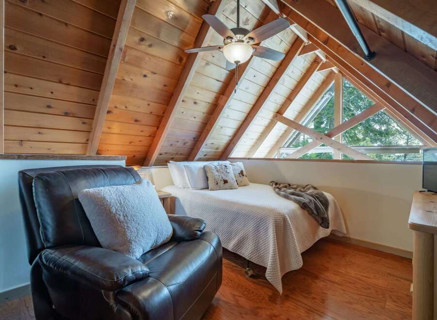Discover the charm of this cozy loft bedroom, perfect for a relaxing retreat.