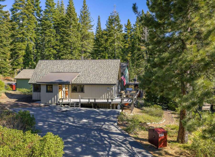 Nestled amidst towering trees, this charming property offers a serene escape.