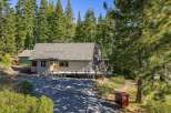 Nestled amidst towering trees, this charming property offers a serene escape.