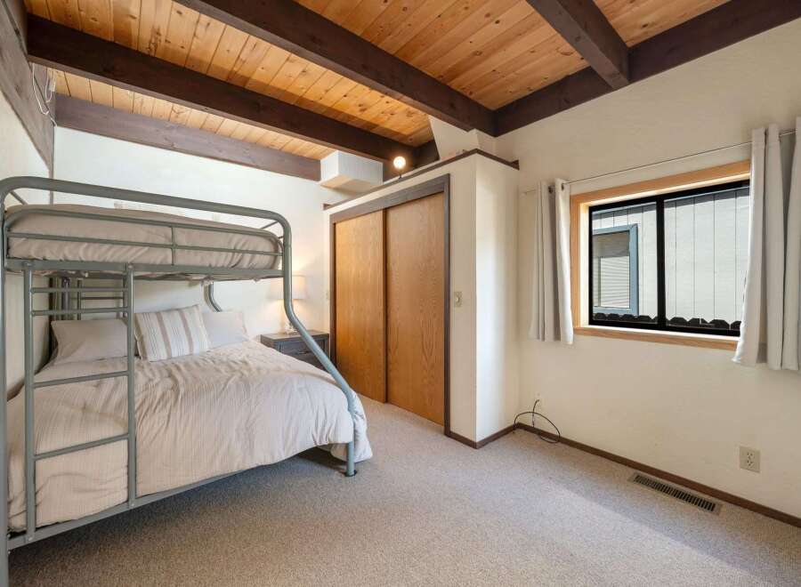This cozy bedroom features a unique bunk bed, perfect for guests or kids.