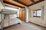 This cozy bedroom features a unique bunk bed, perfect for guests or kids.