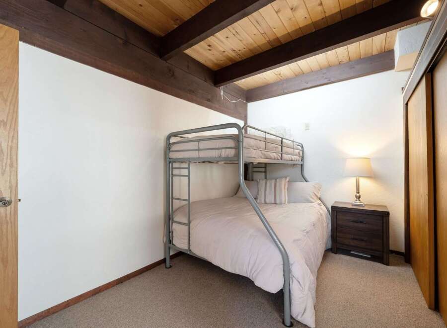 This cozy bedroom features a stylish bunk bed, perfect for accommodating guests or family members.