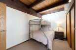 This cozy bedroom features a stylish bunk bed, perfect for accommodating guests or family members.