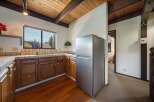 Step into this charming kitchen, featuring warm wooden cabinetry and a stainless steel refrigerator.