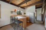 This charming kitchen features a cozy breakfast bar with seating for three, perfect for casual dining or entertaining.