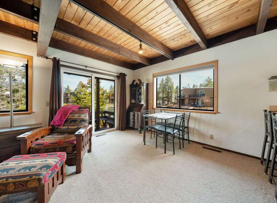Step into this inviting living space, featuring a cozy armchair and ottoman, perfect for relaxing.