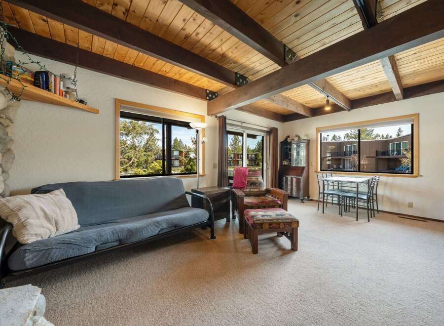 Step into this inviting living space, featuring a cozy futon and a charming seating area.