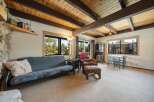 Step into this inviting living space, featuring a cozy futon and a charming seating area.