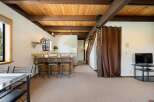 Step into this inviting space featuring a warm, wooden ceiling and exposed beams, creating a cozy atmosphere.