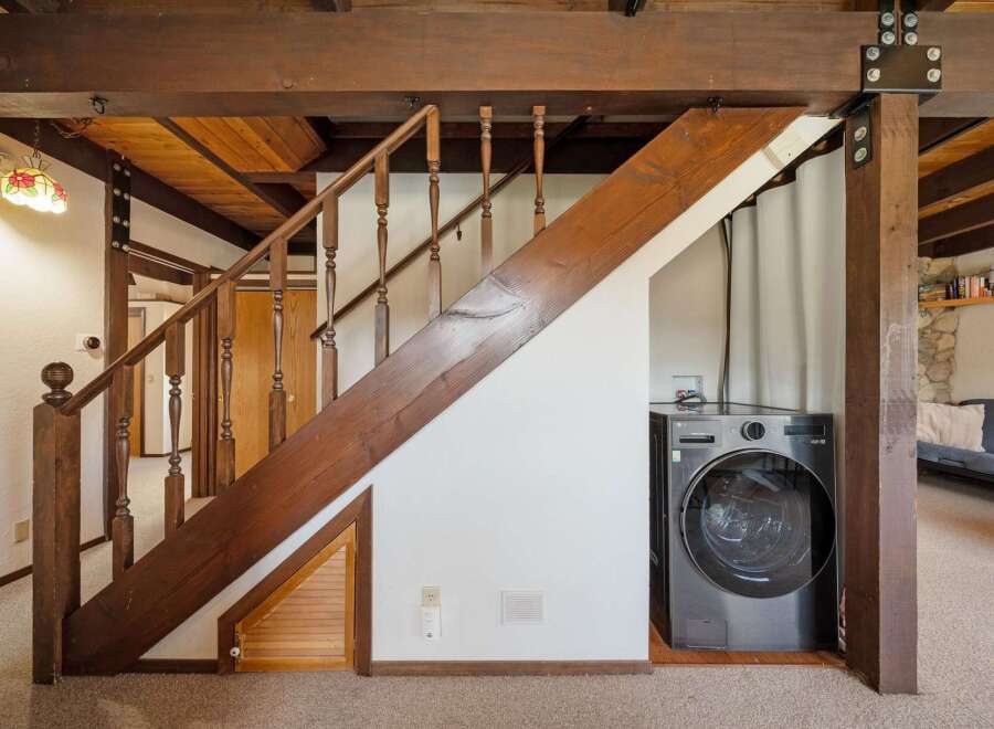 Discover the charm of this unique property featuring a beautifully crafted staircase with wooden accents.