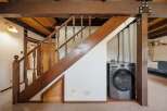 Discover the charm of this unique property featuring a beautifully crafted staircase with wooden accents.