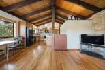 Step into this stunning home featuring a warm and inviting interior with beautiful wooden floors and a vaulted ceiling.