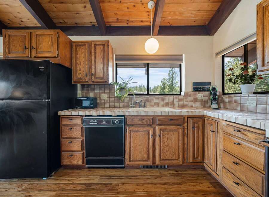 Step into this charming kitchen, featuring warm wooden cabinetry and a classic design.