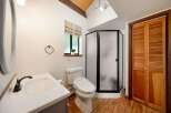 Step into this charming bathroom featuring a modern shower and a stylish vanity.