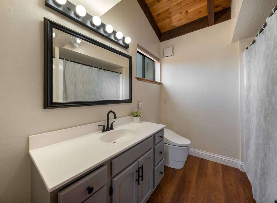Step into this beautifully designed bathroom, featuring a modern vanity with ample storage and a sleek countertop.