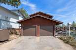 This charming property features a two-car garage with a classic design, perfect for storing vehicles and other belongings.