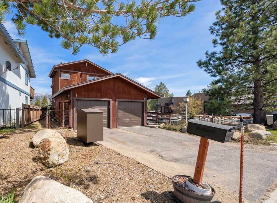 This charming property boasts a beautiful wooden exterior and a convenient two-car garage.