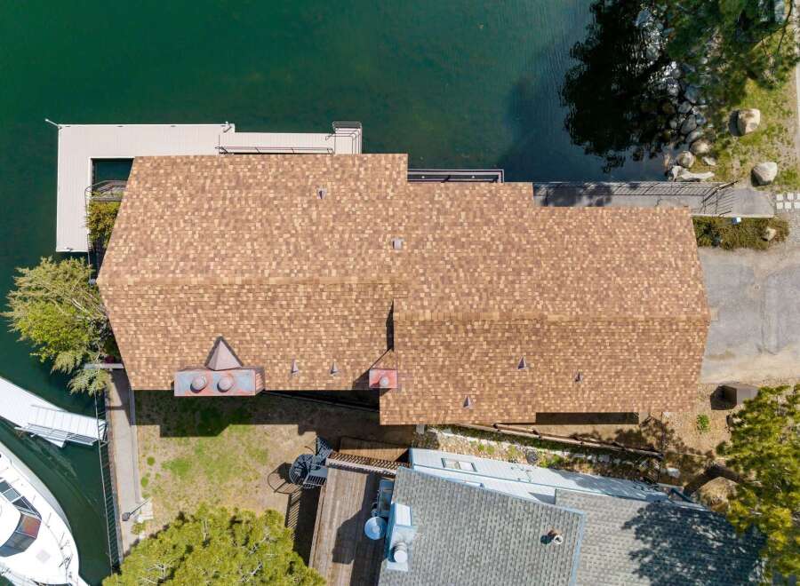 This stunning waterfront property boasts a beautifully designed home with a spacious roof, perfect for enjoying the scenic views.