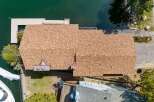 This stunning waterfront property boasts a beautifully designed home with a spacious roof, perfect for enjoying the scenic views.