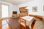 This charming dining area features a cozy wooden table and chairs, perfect for enjoying meals with family and friends.