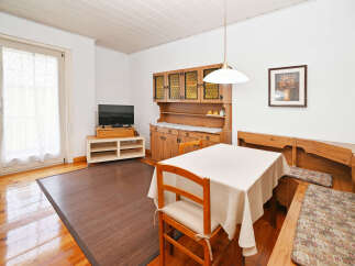 This charming dining area features a cozy wooden table and chairs, perfect for enjoying meals with family and friends.