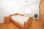 This charming bedroom features a classic wooden bed frame, complemented by matching nightstands.