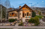 This stunning home boasts a beautiful stone facade and a welcoming front porch, perfect for enjoying the mountain views.