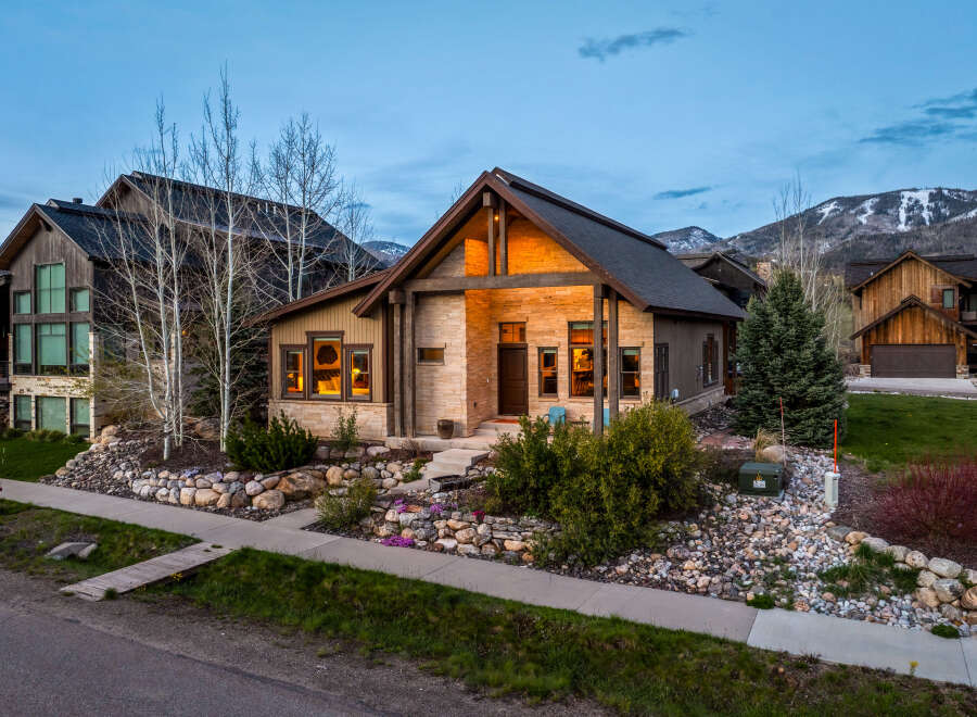 This stunning property boasts a beautiful exterior with a stone facade and a charming wooden door.