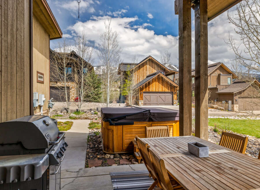 Enjoy outdoor living at its finest with this stunning property featuring a spacious patio and a luxurious hot tub.