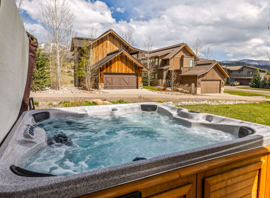 Relax and unwind in this luxurious hot tub, perfect for enjoying the stunning mountain views.