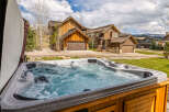 Relax and unwind in this luxurious hot tub, perfect for enjoying the stunning mountain views.