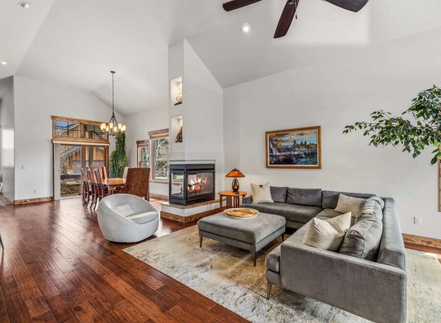 Step into luxury with this stunning living space, featuring a cozy fireplace and a modern sectional sofa.