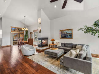 Step into luxury with this stunning living space, featuring a cozy fireplace and a modern sectional sofa.