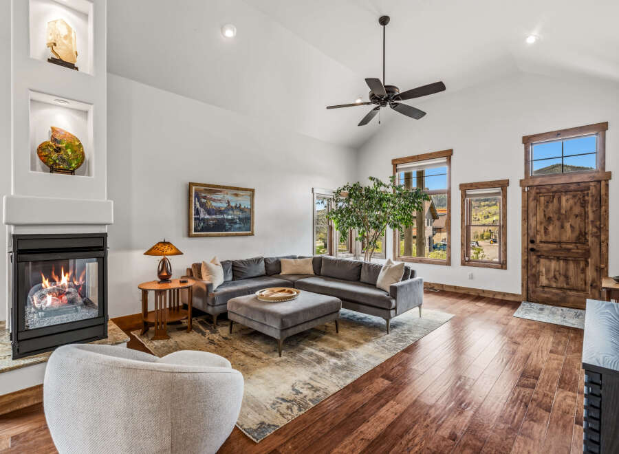 Step into luxury with this stunning living room, featuring a cozy fireplace and a stylish sectional sofa.