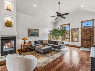 Step into luxury with this stunning living room, featuring a cozy fireplace and a stylish sectional sofa.