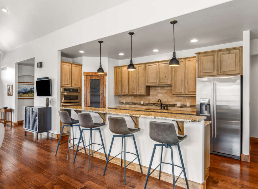 This stunning kitchen boasts a modern design with sleek cabinetry and a spacious island, perfect for entertaining.